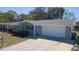 Charming single-story home with a well-maintained lawn, two-car garage and a covered front porch at 7144 Fairfax Dr, Port Richey, FL 34668
