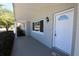 Welcoming front porch featuring a brick facade, classic entry door, and a shaded sitting area at 7144 Fairfax Dr, Port Richey, FL 34668
