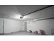 Spacious garage with white walls, and an electric garage door opener at 7144 Fairfax Dr, Port Richey, FL 34668