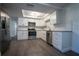 Updated kitchen featuring stainless steel appliances, white cabinets, and a stylish subway tile backsplash at 7144 Fairfax Dr, Port Richey, FL 34668