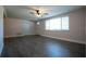 Bright living room with sleek flooring, a ceiling fan, and natural light from a large window at 7144 Fairfax Dr, Port Richey, FL 34668