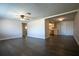 Open living room with modern flooring seamlessly flowing into an adjacent room with updated finishes at 7144 Fairfax Dr, Port Richey, FL 34668