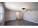 Well-lit living room offers modern flooring and a ceiling fan at 7144 Fairfax Dr, Port Richey, FL 34668