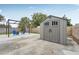 Backyard storage shed near a patio and a pergola, all surrounded by a wooden fence at 7402 Sherren Dr, Tampa, FL 33619