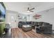 Cozy living room featuring a comfortable sectional sofa, wood-look floors, and ample natural light at 7402 Sherren Dr, Tampa, FL 33619