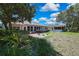 Expansive backyard with lush greenery and a patio, perfect for outdoor activities at 8045 Sugarbush Dr, Spring Hill, FL 34606