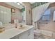 Cozy bathroom featuring a single vanity with pink accents and white cabinets at 8045 Sugarbush Dr, Spring Hill, FL 34606