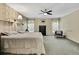 Comfortable bedroom featuring a queen bed, patterned wallpaper, neutral carpeting, and classic dark wood furniture at 8045 Sugarbush Dr, Spring Hill, FL 34606
