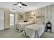 Comfortable bedroom featuring twin beds, patterned wallpaper, neutral carpeting, and adjacent bathroom at 8045 Sugarbush Dr, Spring Hill, FL 34606