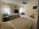Comfortable bedroom with soft natural light, twin beds, and a flat-screen television for relaxation at 8045 Sugarbush Dr, Spring Hill, FL 34606