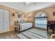 Comfortable bedroom featuring a stained glass window, neutral walls, laminate flooring, and closet at 8045 Sugarbush Dr, Spring Hill, FL 34606