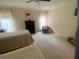 Inviting bedroom showcasing twin beds, a dark wood dresser, and a comfortable sitting area at 8045 Sugarbush Dr, Spring Hill, FL 34606