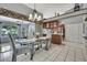 Open dining area flows into the kitchen, featuring a chandelier and sliding glass doors at 8045 Sugarbush Dr, Spring Hill, FL 34606
