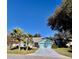 Well-maintained home featuring a blue exterior, two palm trees and an attached garage at 8045 Sugarbush Dr, Spring Hill, FL 34606