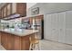 Modern kitchen features stainless steel appliances, wooden cabinetry, and a breakfast bar at 8045 Sugarbush Dr, Spring Hill, FL 34606