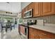 Modern kitchen boasts stainless steel appliances, light countertops, and an adjacent dining area at 8045 Sugarbush Dr, Spring Hill, FL 34606