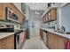 Spacious kitchen featuring stainless steel appliances, wood cabinets, and seamless access to dining area at 8045 Sugarbush Dr, Spring Hill, FL 34606