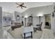 Bright living room features high ceilings, tile floors, and is decorated with modern furniture at 8045 Sugarbush Dr, Spring Hill, FL 34606