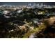 Night aerial view of neighborhood homes with city skyline in the background, showcasing the urban community at 951 9Th S Ave, St Petersburg, FL 33705