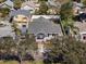 Aerial view of a single-story home with a gray roof and mature trees at 951 9Th S Ave, St Petersburg, FL 33705