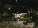 Scenic aerial view of the single-Gathering home with the landscaped yard, brick steps, and front porch at night at 951 9Th S Ave, St Petersburg, FL 33705