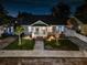 Charming single-Gathering home with a manicured lawn, brick steps, and inviting front porch illuminated at night at 951 9Th S Ave, St Petersburg, FL 33705