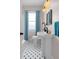 Inviting bathroom with a pedestal sink, black hardware, and blue accents for a fresh feel at 951 9Th S Ave, St Petersburg, FL 33705