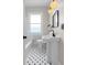 Classic bathroom featuring a pedestal sink, tiled floor, and a window for natural lighting at 951 9Th S Ave, St Petersburg, FL 33705