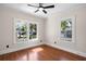 Bedroom with hardwood floors, white trim, a ceiling fan, and large windows at 951 9Th S Ave, St Petersburg, FL 33705