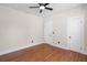 An empty bedroom with hardwood floors, two doors, and a ceiling fan at 951 9Th S Ave, St Petersburg, FL 33705