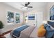Bedroom with hardwood floors, white trim, a ceiling fan, and a comfortable bed at 951 9Th S Ave, St Petersburg, FL 33705
