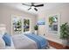 Bright bedroom with hardwood floors, ceiling fan, and a large window for natural light and a nice exterior view at 951 9Th S Ave, St Petersburg, FL 33705