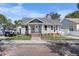 Charming single-story home featuring a brick-lined walkway and colorful flags at 951 9Th S Ave, St Petersburg, FL 33705