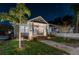 Charming single-Gathering home with a manicured lawn, brick steps, and inviting front porch illuminated at night at 951 9Th S Ave, St Petersburg, FL 33705