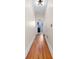 Hallway with hardwood floors leading to a bright kitchen, showcasing the home's layout at 951 9Th S Ave, St Petersburg, FL 33705