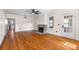 Bright living room features a brick fireplace, hardwood floors, ceiling fan and natural light from the windows at 951 9Th S Ave, St Petersburg, FL 33705