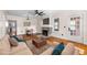 Staged living room with fireplace, hardwood floors, ceiling fan and neutral-toned furniture at 951 9Th S Ave, St Petersburg, FL 33705