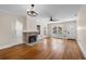 Open living room with fireplace, hardwood floors, ceiling fan and natural light from the windows at 951 9Th S Ave, St Petersburg, FL 33705