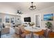 Staged living room with hardwood floors, ceiling fan, and a dining area, offering a cozy and inviting space at 951 9Th S Ave, St Petersburg, FL 33705
