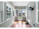 Enclosed sunroom featuring wood-look floors, an exterior fan, and several windows for natural light at 951 9Th S Ave, St Petersburg, FL 33705