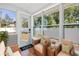 Staged sunroom featuring wood floors, large windows, and wicker furniture at 951 9Th S Ave, St Petersburg, FL 33705