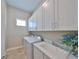 Well-organized laundry room with built-in cabinets, sink, and modern washer and dryer at 1009 Seagrape Dr, Ruskin, FL 33570