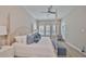 Serene bedroom features a wood bed frame, plush pillows, and sunny window views at 1009 Seagrape Dr, Ruskin, FL 33570