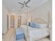 Bright, airy bedroom with a four-poster bed, en-suite bathroom, and ample closet space at 1009 Seagrape Dr, Ruskin, FL 33570