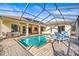 Screened-in pool with patio seating and a well-maintained deck at 10364 Locker Dr, Spring Hill, FL 34608