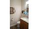 Bathroom with a wood vanity, toilet, sink, and decorative wall art at 104 Gloucester Blvd # 340, Sun City Center, FL 33573