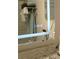 Close up of a modern bathroom mirror with a lighted edge and a granite counter at 104 Gloucester Blvd # 340, Sun City Center, FL 33573