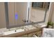 Close up of a bathroom sink with a lighted mirror, granite counter, and modern faucet at 104 Gloucester Blvd # 340, Sun City Center, FL 33573