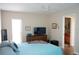 Bright bedroom with a ceiling fan, television and a view of the en suite bathroom at 104 Gloucester Blvd # 340, Sun City Center, FL 33573