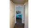 A look through a doorway into a bedroom with blue bedding, a decorative headboard, and wood flooring at 104 Gloucester Blvd # 340, Sun City Center, FL 33573